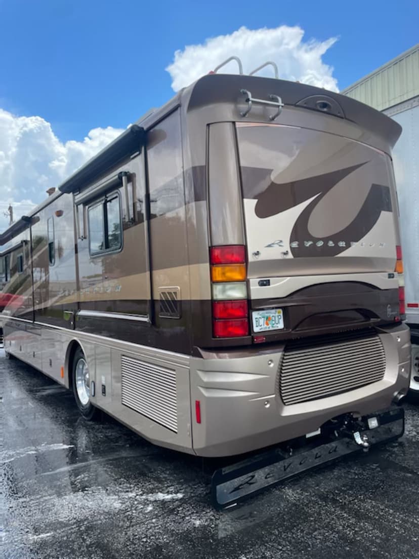 Luxury RV parked under a bright sky, showcasing sleek design and modern features.